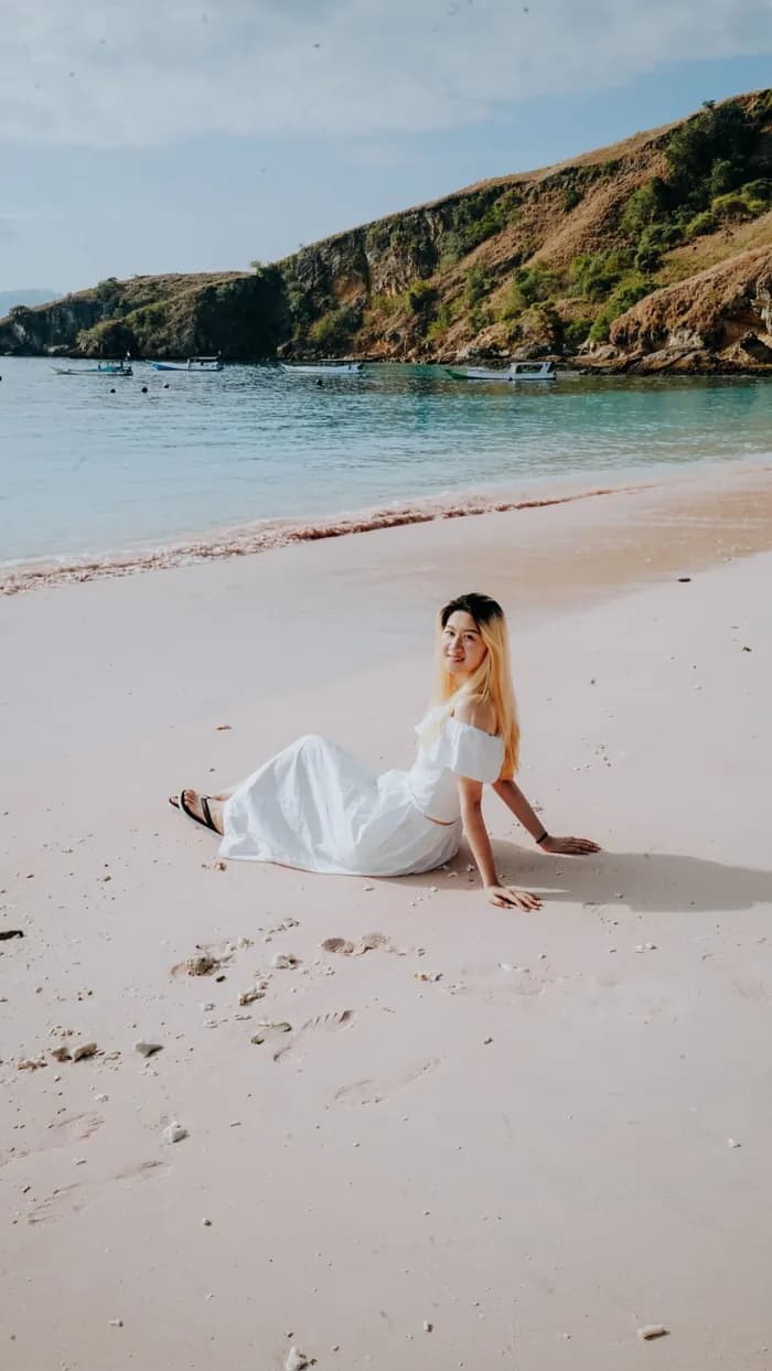 Traveler in a white dress on Pink Beach