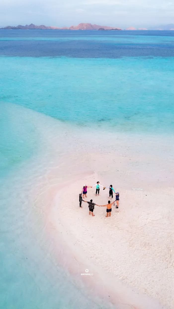Aerial view of travelers on a Komodo sandbar