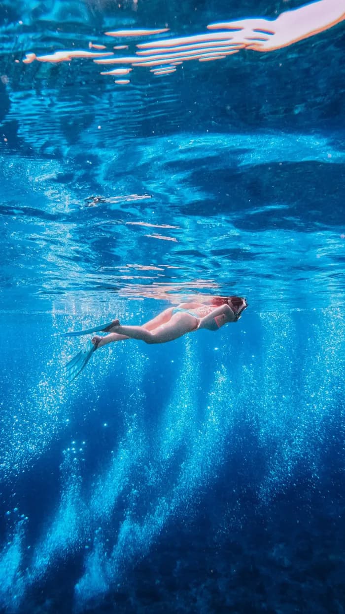 Underwater snorkeling in deep blue Komodo water