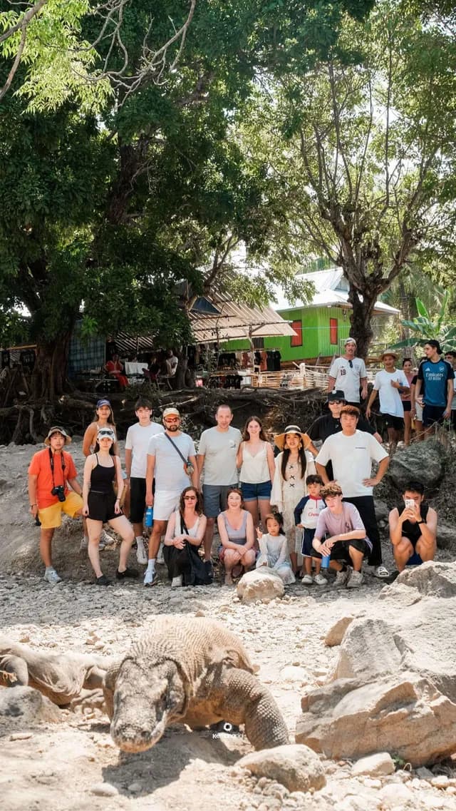 Group tour photo with a Komodo dragon in the village